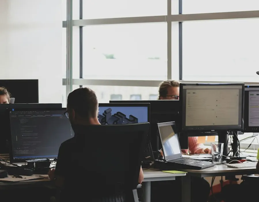 Testing team at work on multiple screens