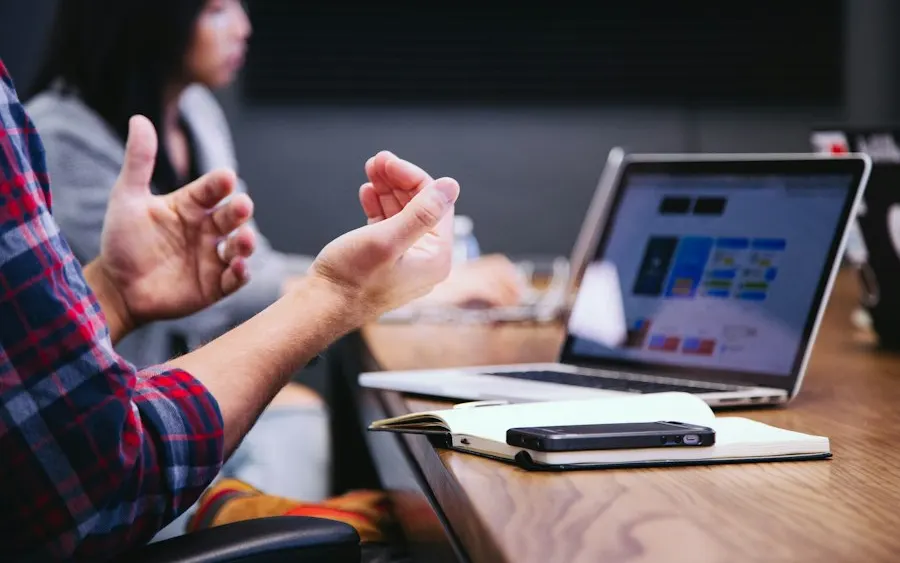 Business users reviewing a system together at a laptop